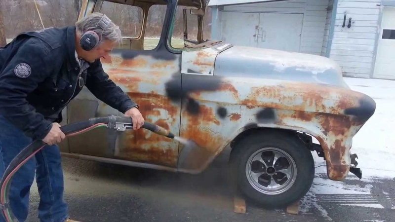 Auto restoration by removing rust with sandblasting.