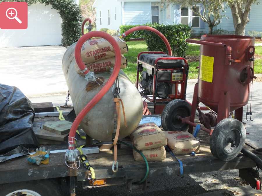 Sandblasting concrete driveway paint removal stripping