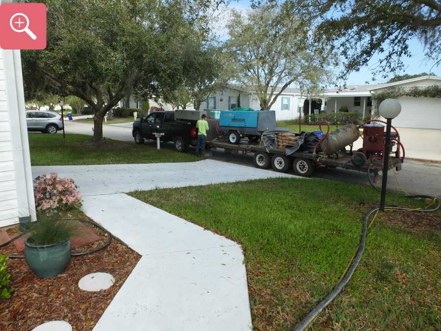 Sandblasting concrete driveway paint removal stripping