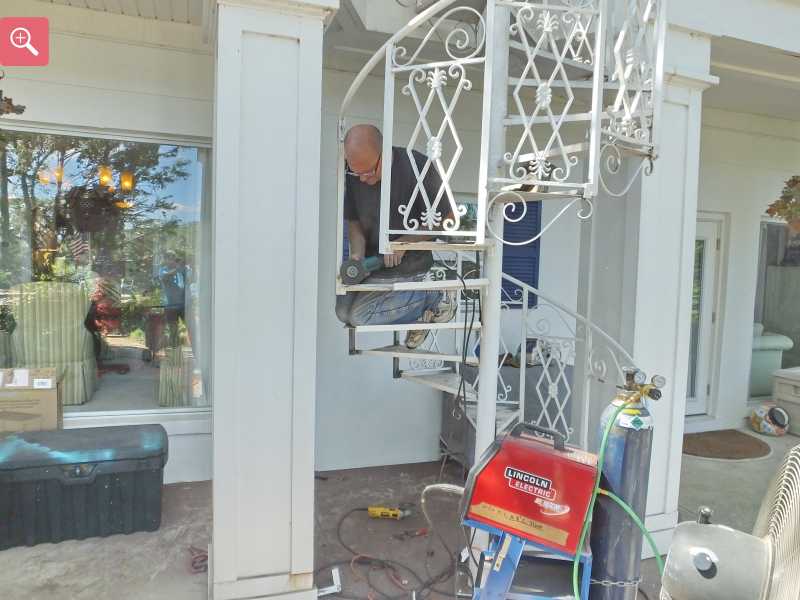 Cutting the rusty metal out of the stair case