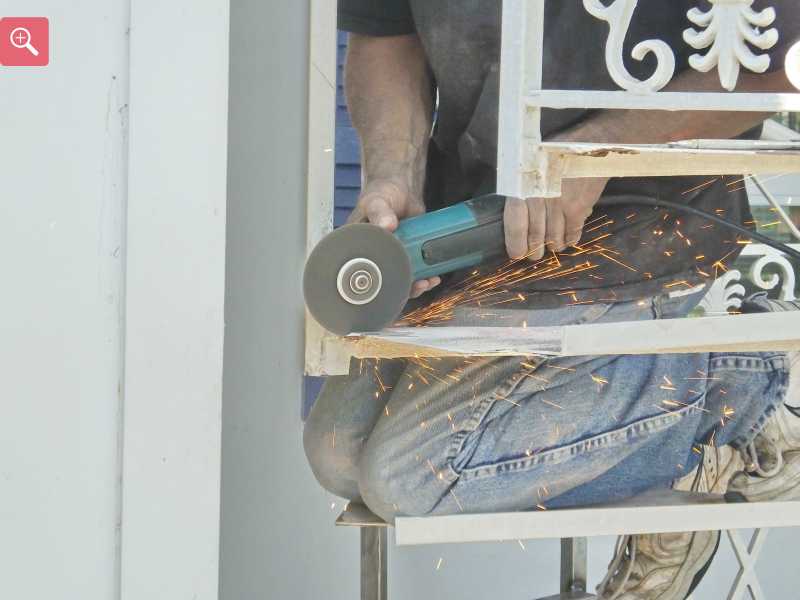 Cutting the rusty metal out of the stair case