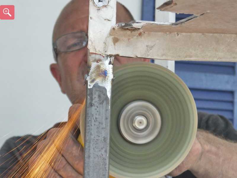 Grinding the welds smoot on the repaired staircase