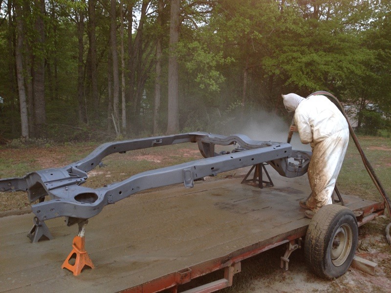 Removing rust from a automobile with st augustine mobile sand blasting.