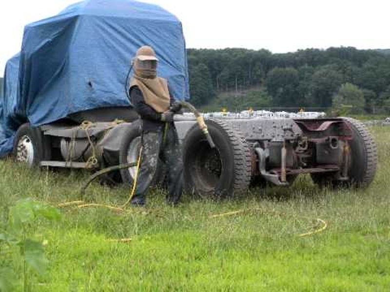 sand blasting a truck frame