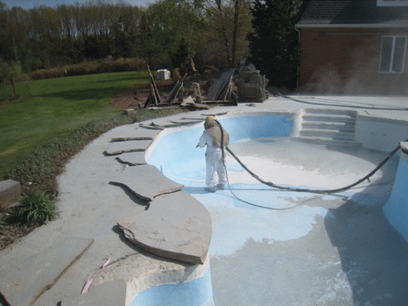 Sandblasting swimming pools so they can be repainted new.